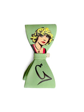 Load image into Gallery viewer, Green bow clips with a graphic design of a googoosh