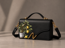 Load image into Gallery viewer, Signature N Lemon Tree black leather handbag with a hand-painted potted lemon tree and gold N clasp