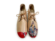 Load image into Gallery viewer, Beige leather chukka shoes with a hand-painted Queen design and bold red paint on the toes.
