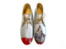 Load image into Gallery viewer, Gray  leather chukka shoes with a hand-painted Queen design and bold red paint on the toes.
