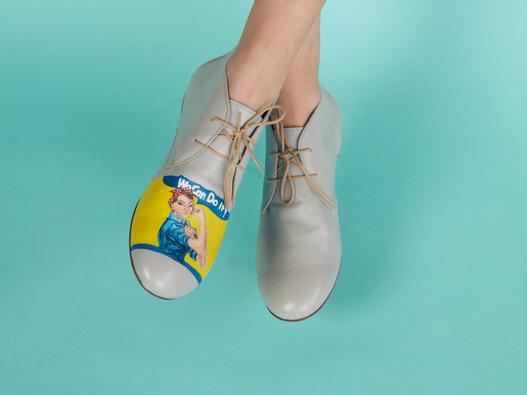 Stylish gray shoes featuring a bold and artistic Super Woman design.