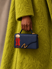 Load image into Gallery viewer, Signature N Turkaman navy leather handbag carried by a model wearing a green coat
